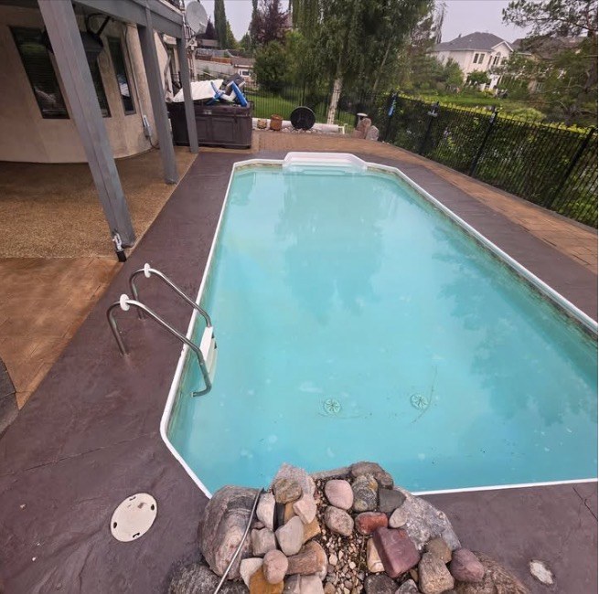 The same pool deck after sealing with a rich, darker tinted finish