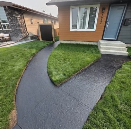 The same front walkway after sealing with a deep charcoal tinted finish