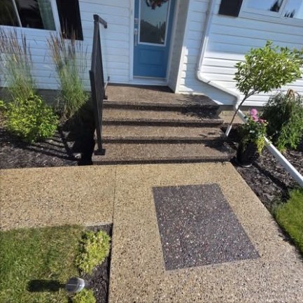 Sealed exposed aggregate front steps and walkway with a dark aggregate inlay