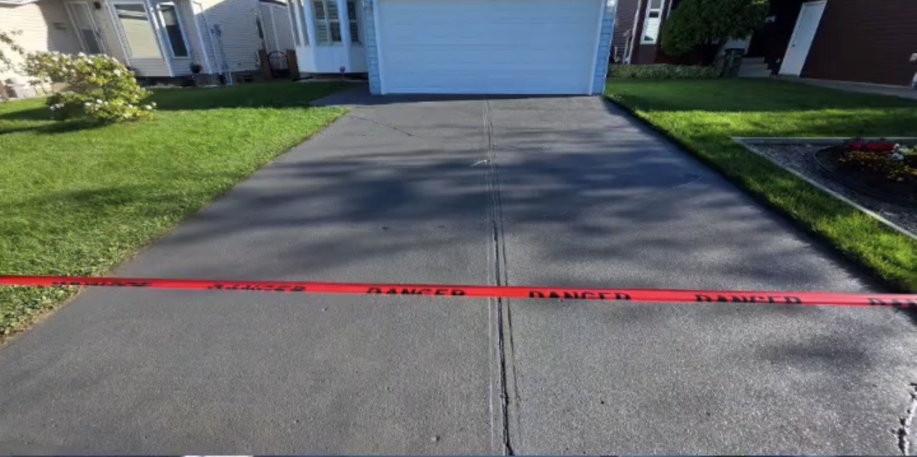 Concrete driveway with visible cracks before repair and sealing