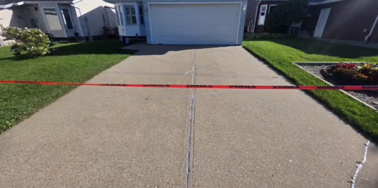 The same driveway after crack repair and resealing