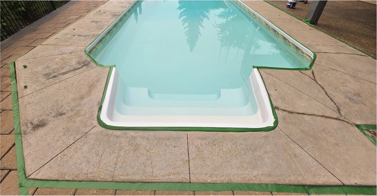 Stamped concrete pool deck masked off and prepared for resealing