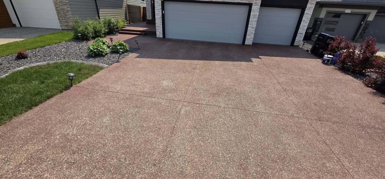 Red exposed aggregate driveway looking dull and faded before sealing